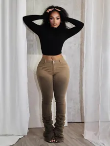 Modisches schwarzes Langarm-Crop-Top kombiniert mit khakifarbener Vintage-Hose im Stacked-Look