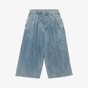 Detailed front view of women's street fashion wide-leg denim pants with pleated waist
