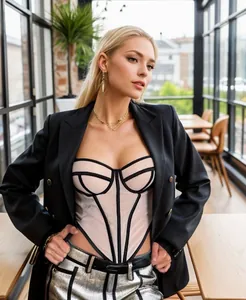 Detail view showing the intricate black contrast lines on a sexy beige corset top.