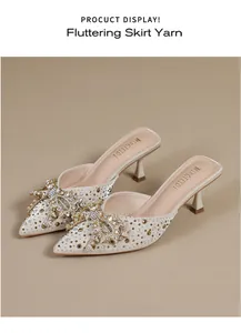 Elegante slippers met spitse neus en hoge hakken met een mooi strass-strikdetail
