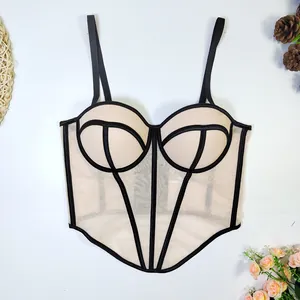 Close-up of sexy beige mesh corset camisole with black contrasting bone lines