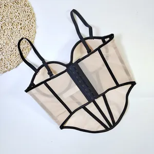 Detail view of beige mesh corset top with black boning and hook-and-eye closure