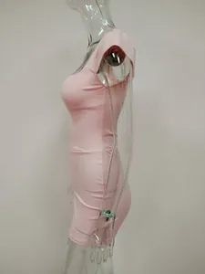 Side view of a sexy pink bodycon mini dress on a clear mannequin