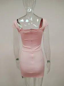 Detailed back view of a pink bodycon mini dress featuring off-shoulder design and zipper closure