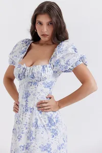 Detailed view of white puff sleeve dress featuring blue porcelain floral print and gathered bust
