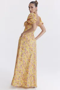 Elegant yellow floral maxi dress with puff sleeves and backless detail shown from side