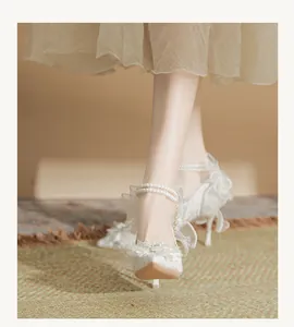 French fairy style white lace wedding high heels with elegant pearl ankle straps.