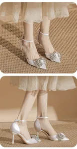 Elegant white satin pointed-toe stiletto heels with luxury crystal bow embellishment