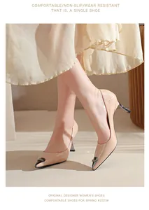 Detail view showing elegant beige patent leather pointed-toe high heels with kitten heel.