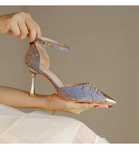 Close-up of lavender textured high heels with metallic gold pointed toe and ankle strap