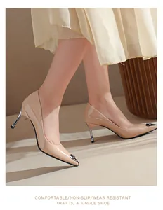 Elegant nude patent leather pointed-toe stiletto heels shown on model with skirt