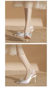 Elegant white satin pointed toe stiletto heels with luxury crystal bow embellishment