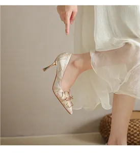 Detail of French stiletto heels with elegant geometric pattern and decorative toe flower