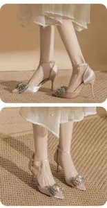 Detailed view of champagne satin stilettos featuring shimmering rhinestone bows.