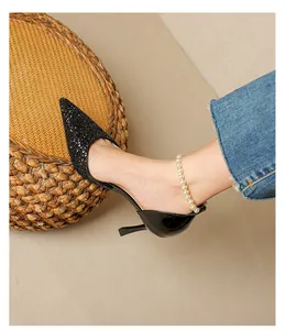 Detailed view of elegant black glitter pointed-toe stiletto pumps with chic cutout