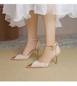 Elegant pointed-toe satin high heels featuring a delicate ankle strap and metallic gold toe cap