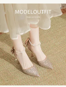 Elegant champagne gold sequined bridal pumps with delicate pearl ankle strap detail