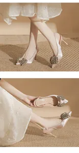 Detailed view of champagne satin pointed toe stiletto heels with crystal bow embellishment.