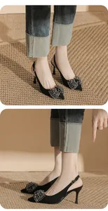 Elegant black pointed-toe slingback heels featuring a crystal beaded bow detail