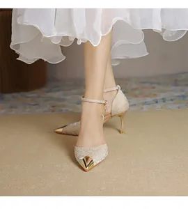 Elegant textured satin pointed-toe heels featuring a gold metal tip and slim ankle strap