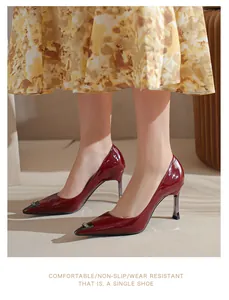 Elegant wine red patent leather pointed-toe high heels shown on model with metallic detail