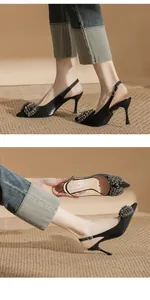 Elegant black pointed-toe slingback pumps with sparkling rhinestone flower detail.
