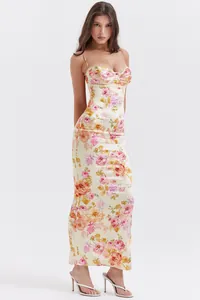 Full length side view of a floral print maxi dress featuring gathered bust and lace trim