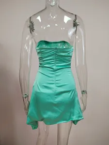 Detailed back view of a mint green strapless mini dress with zipper and ruching details