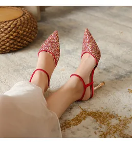 Detailed view showing the shimmering red glitter texture of these pointed-toe stiletto heels