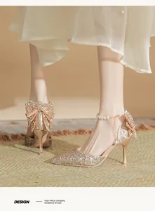 Elegant champagne sequin high heels with pearl ankle strap and large bow detail for weddings