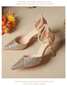Elegant pointed-toe stiletto heels with champagne glitter and pearl ankle strap detail.