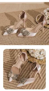 Elegant champagne satin pointed toe stiletto heels with sparkling crystal bow detail