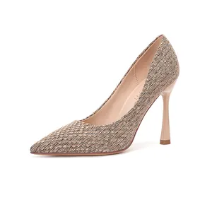 Close-up of elegant woven pointed-toe high-heeled pump with slender stiletto heel.