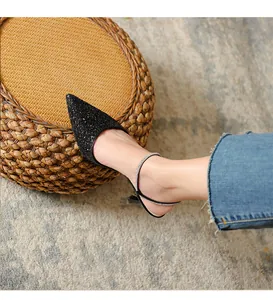 Detailed view of elegant black glitter pointed toe kitten heels with rhinestone straps