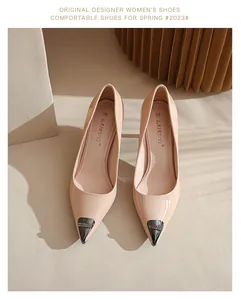 Close-up of elegant nude pointed-toe patent leather high heels with crystal tip detail