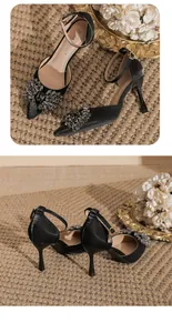 Close-up of elegant black pointed-toe pumps with rhinestone bow and ankle strap