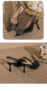 Elegant black pointed toe stiletto heels featuring a luxury rhinestone buckle detail.
