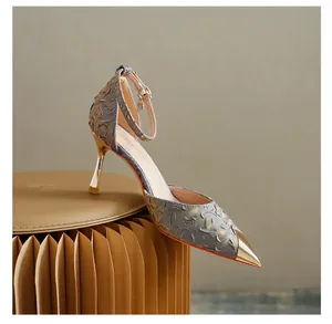 Close-up of elegant pointed-toe stiletto high heels with metallic gold toe cap detail