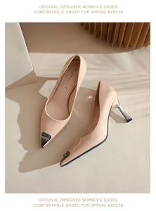 Macro detail of nude pointed-toe patent leather high heels with sparkling metallic tip