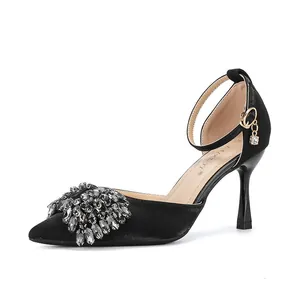 Side view of elegant black pointed toe stiletto heels featuring luxury crystal toe decoration