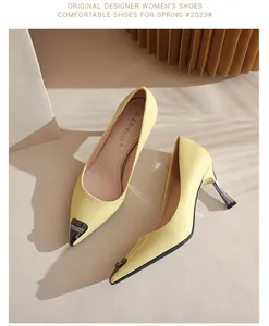 Detailed view of yellow patent leather pointed-toe pumps with metallic accents.