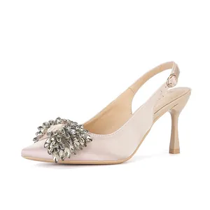 Detailed side view of elegant pointed toe slingback high heels with crystal bow embellishment