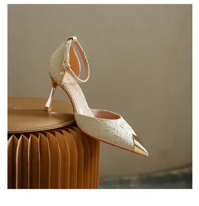 Side view detail of champagne satin pumps with metallic toe cap and ankle strap