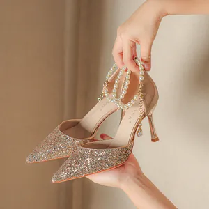 Elegant champagne gold glitter pointed toe stiletto pumps featuring pearl ankle strap decor