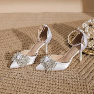 Elegant white satin pointed-toe stilettos with rhinestone bow decoration