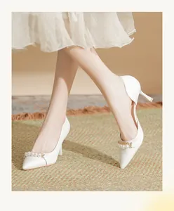 Elegant white pointed-toe high heels featuring pearl and gold chain decoration details