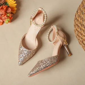 Elegant gold glitter pointed toe pumps with pearl ankle straps and slim high heels