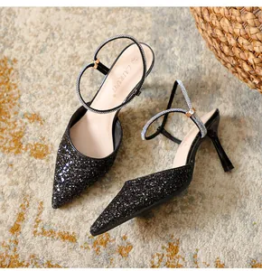 Elegant black glitter pointed toe stiletto heels featuring sparkly rhinestone straps.