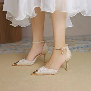 Champagne satin pointed toe stiletto heels with ankle strap and gold metal tip