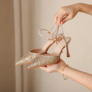 Elegant champagne gold glitter pointed-toe high heels with rhinestone straps